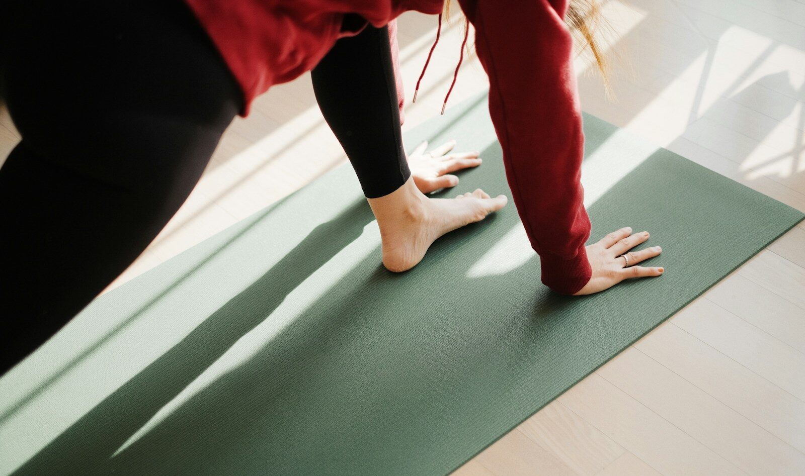 a person standing on a yoga mat on the floor
